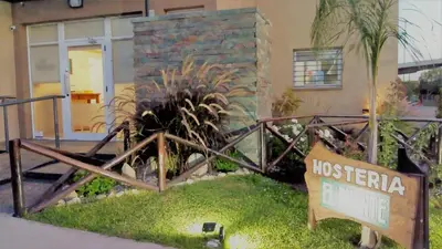 a sign in front of a house with a fence at Hostería Boutique El Puente Adults Only in Merlo