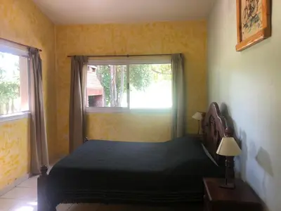 a bedroom with a bed and a window at La Casa de Wanda in Villa de Las Rosas