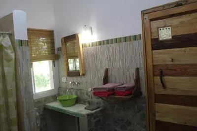 a bathroom with a green sink and a mirror at La Casa de Wanda in Villa de Las Rosas