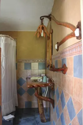 a bathroom with a wooden sink and a mirror at La Casa de Wanda in Villa de Las Rosas