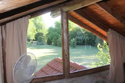 a window in a house with a fan at La Casa de Wanda in Villa de Las Rosas