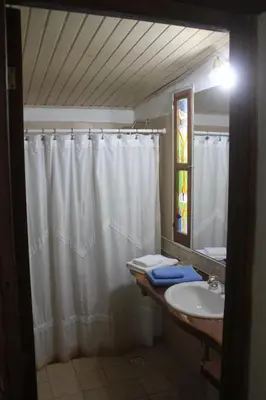 a bathroom with a shower curtain and a sink at La Casa de Wanda in Villa de Las Rosas