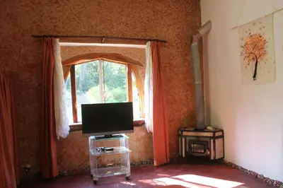 a living room with a tv and a window at La Casa de Wanda in Villa de Las Rosas