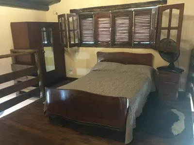 a bedroom with a bed and a wooden floor at CABAÑA EN TANTI in Tanti