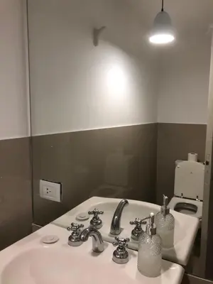 a bathroom with a white sink and a mirror at ALOHA Güemes Premium, 2 dorm con Vista a las Sierras in Cordoba
