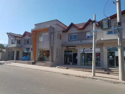 a row of shops on a city street at Aparts Piscu Yaco Almendros in Merlo