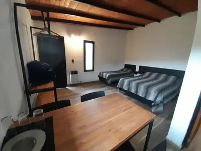 a living room with a table and a couch at Corral de Pirca in Los Reartes