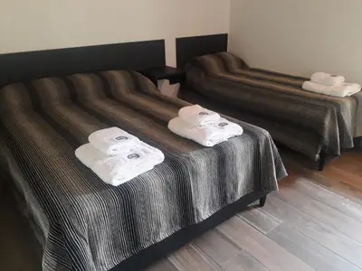 a hotel room with two beds with towels on them at Corral de Pirca in Los Reartes
