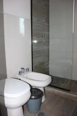 a bathroom with a toilet and a sink and a shower at Corral de Pirca in Los Reartes