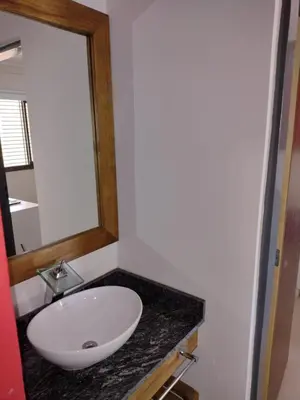 a bathroom with a white sink and a mirror at Magenta Departamentos in Mina Clavero