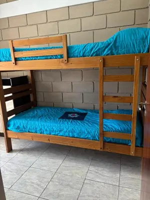 a set of bunk beds with a blue bed at Malaquias in Villa Carlos Paz