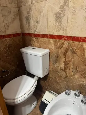a bathroom with a white toilet and a sink at Malaquias in Villa Carlos Paz