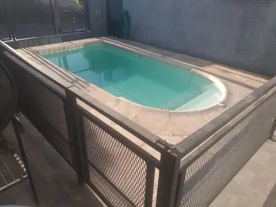 a large swimming pool with a fence around it at Malaquias in Villa Carlos Paz