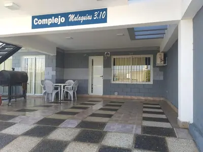 a lobby of a building with a table and chairs at Malaquias in Villa Carlos Paz