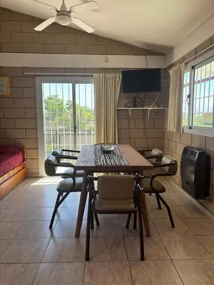 a dining room with a table and chairs in a room at Malaquias in Villa Carlos Paz