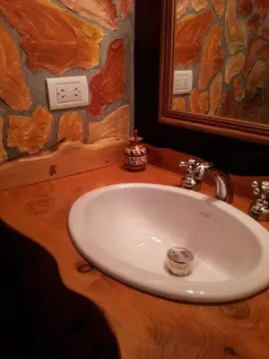a bathroom with a white sink and a mirror at Cabañas Vientos del Sur in Villa Yacanto