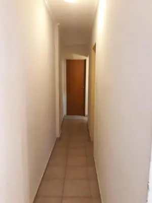 an empty hallway with a door and a tile floor at Departamento Carlos Paz in Villa Carlos Paz