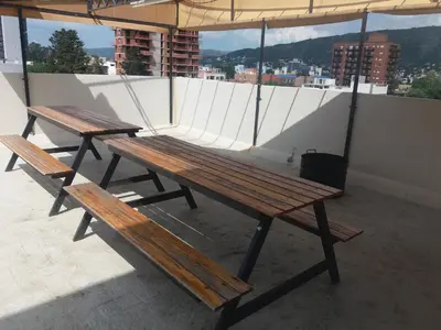 two wooden benches sitting on top of a roof at Departamento Carlos Paz in Villa Carlos Paz