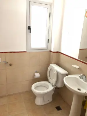 a bathroom with a toilet and a sink at Dpto El Nilo Carlos Villa Paz in Villa Independencia