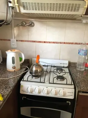 a kitchen with a stove with a tea pot on it at Dpto El Nilo Carlos Villa Paz in Villa Independencia