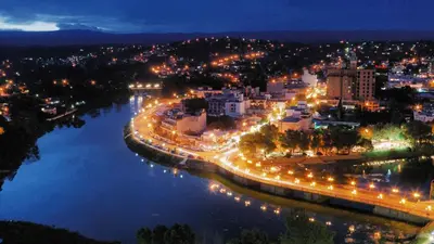 a city at night with a river and street lights at Dpto El Nilo Carlos Villa Paz in Villa Independencia