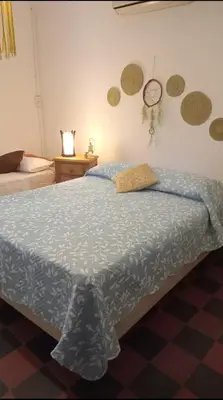 a bedroom with a bed and a clock on the wall at Abbá Departamentos in Mina Clavero