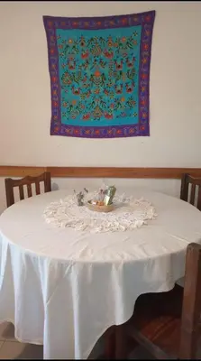 a table with a white table cloth on top of it at Abbá Departamentos in Mina Clavero