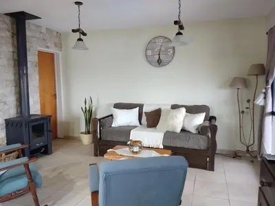 a living room with a couch and a wood stove at Libertad in Villa Yacanto