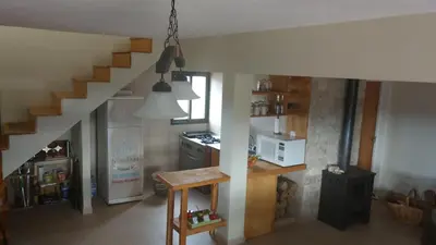 a kitchen with a staircase and a kitchen with a stove at Libertad in Villa Yacanto
