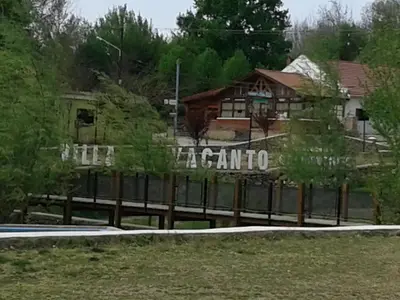 a sign on a fence in front of a house at Libertad in Villa Yacanto