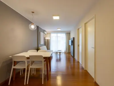 a dining room with a table and white chairs at B131 - Argentina in Cordoba