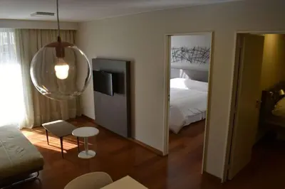 a room with a bedroom with a bed and a mirror at B131 - Argentina in Cordoba