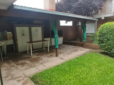 a patio with a table and green drapes at Los 5 de Brochero in Mina Clavero