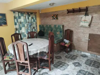 a dining room with a table and some chairs at Los 5 de Brochero in Mina Clavero