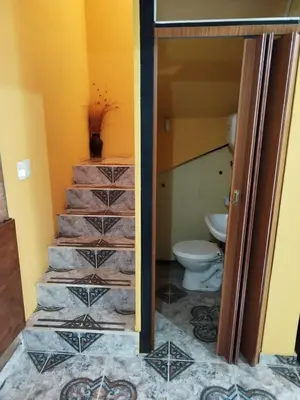 a bathroom with a staircase leading to a toilet at Los 5 de Brochero in Mina Clavero