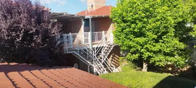 a brick house with a staircase on the side of it at Los 5 de Brochero in Mina Clavero
