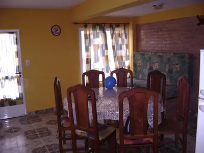a dining room table with chairs and a blue balloon on it at Los 5 de Brochero in Mina Clavero