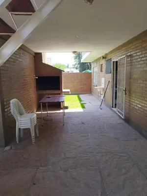 a patio with a table and a chair and a piano at Los 5 de Brochero in Mina Clavero