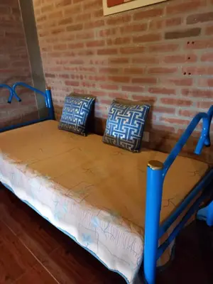 a bed in a room with two pillows on it at Departamento Estela Marys in Mina Clavero