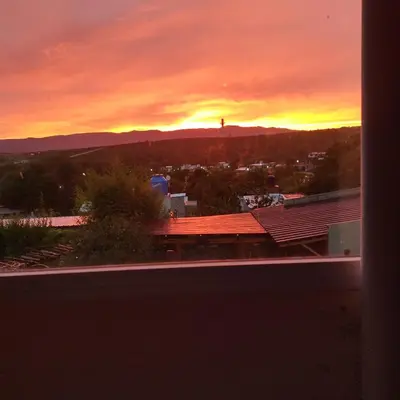 a sunset view from the roof of a building at Talita Cumi in Villa Santa Cruz del Lago