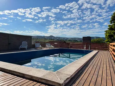 a swimming pool on a deck with a view of the mountains at Casa El Descanso in San Antonio de Arredondo