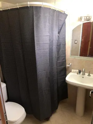 a bathroom with a shower with a toilet and a sink at Casa El Descanso in San Antonio de Arredondo