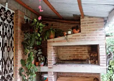 a brick fireplace with potted plants on top of it at Casa de Vero in Mina Clavero