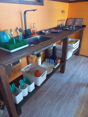 a kitchen counter with a sink and utensils at Cabaña de Campo - Valle de Calamuchita - Sierras de Córdoba in San Clemente