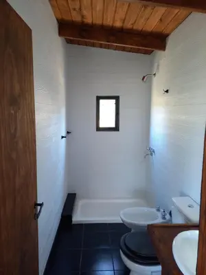 a bathroom with a toilet and a tub and a sink at Cabaña de Campo - Valle de Calamuchita - Sierras de Córdoba in San Clemente