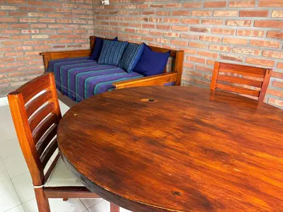 a living room with a table and a couch at Departamentos Los Álamos in Mina Clavero