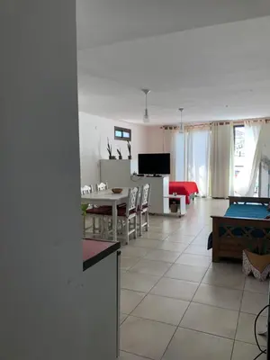 a living room with a kitchen and a dining room at Departamento LA PAZ in Villa Carlos Paz