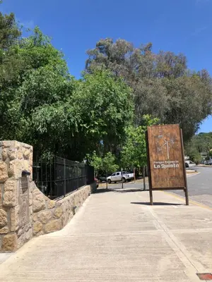 a sign sitting on the side of a sidewalk at Departamento LA PAZ in Villa Carlos Paz