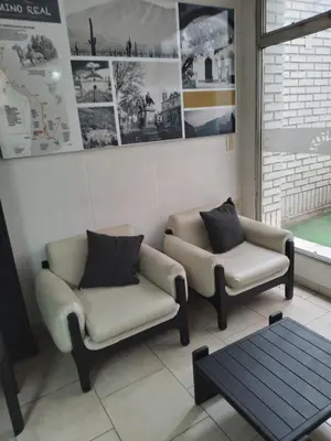 a waiting room with two chairs and a coffee table at Camino Real Hotel in Cordoba