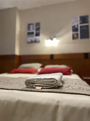 two beds with towels sitting on top of them at Camino Real Hotel in Cordoba